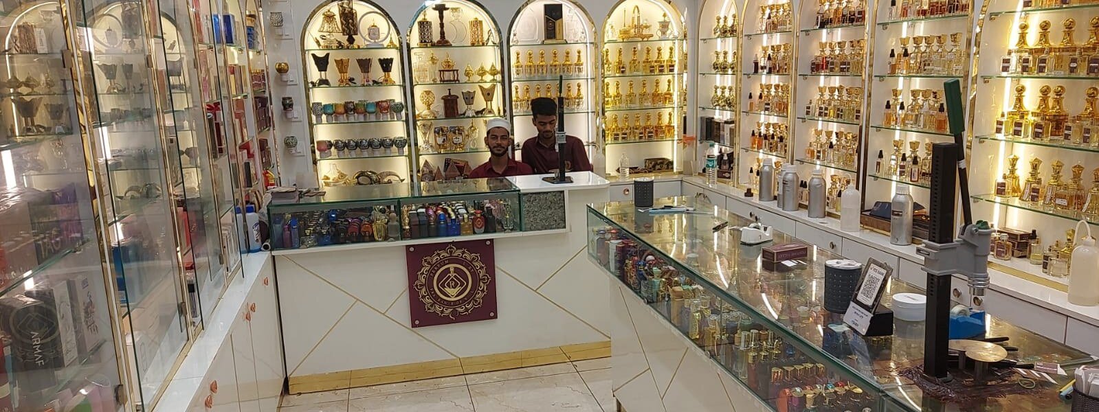 Inside a Perfume Valley store, gold-lit arched shelves of attars and perfumes